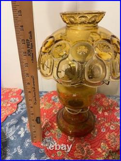 LE Smith electric lamp amber/yellow in color