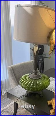 This is a vintage green glass table lamp in the Hollywood Regency style