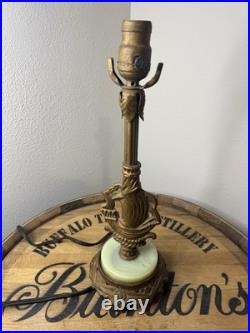 This vintage 1920s table lamp features a on a glowing green uranium slag base