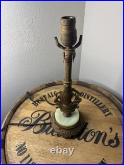 This vintage 1920s table lamp features a on a glowing green uranium slag base
