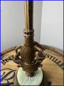 This vintage 1920s table lamp features a on a glowing green uranium slag base This vintage 1920s table lamp features a on a glowing green uranium slag base