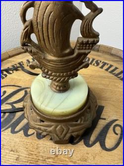 This vintage 1920s table lamp features a on a glowing green uranium slag base